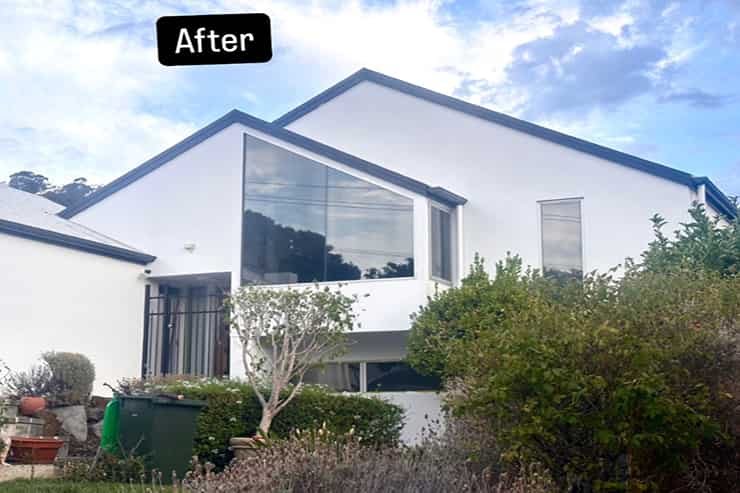 After image of a house featuring newly installed windows, significantly improving its exterior look and overall aesthetic.
