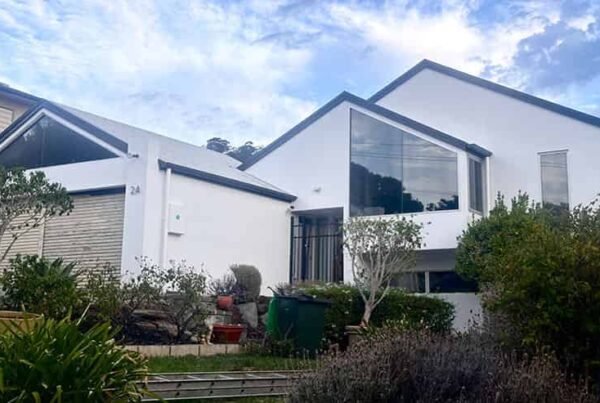 Exterior view of a house with a sizable garage and expansive yard, ideal for service activities.